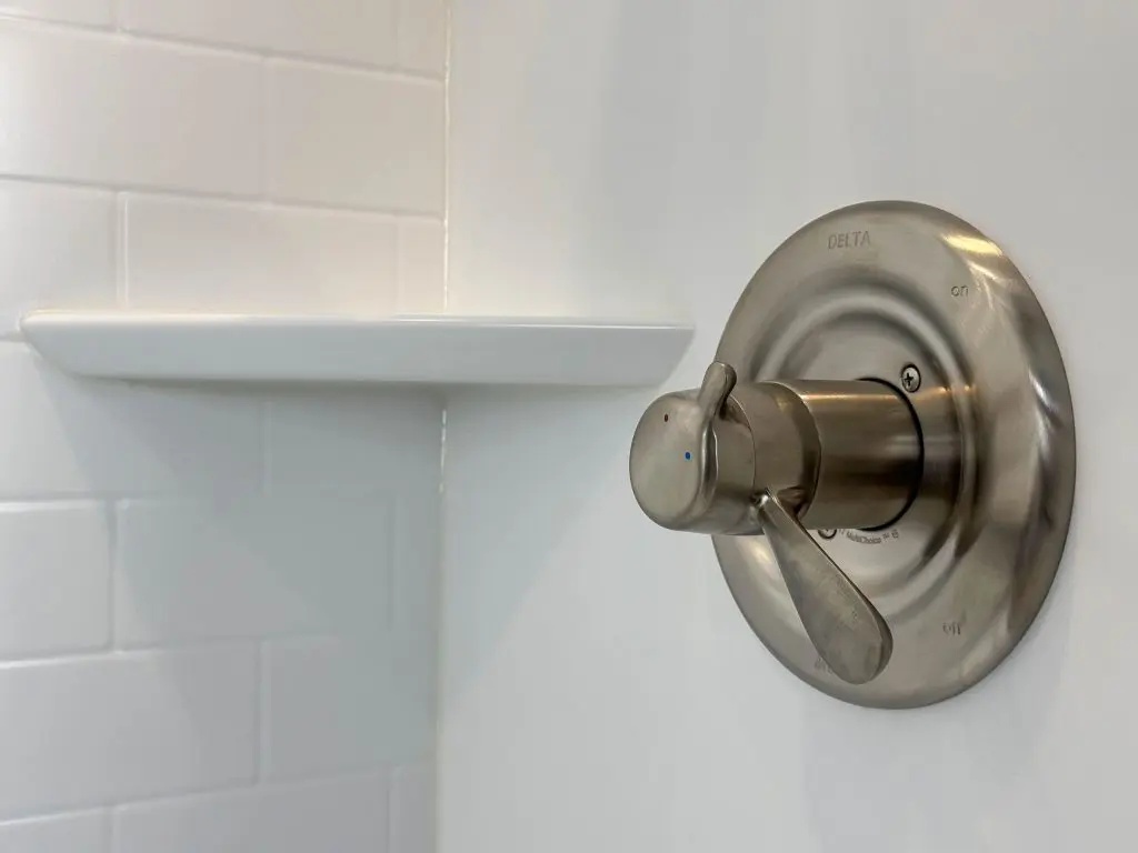 white subway shower with delta valve