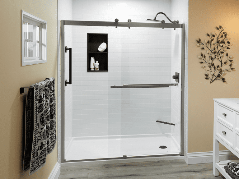 White walk-in shower with sliding barn-style glass doors and black hardware