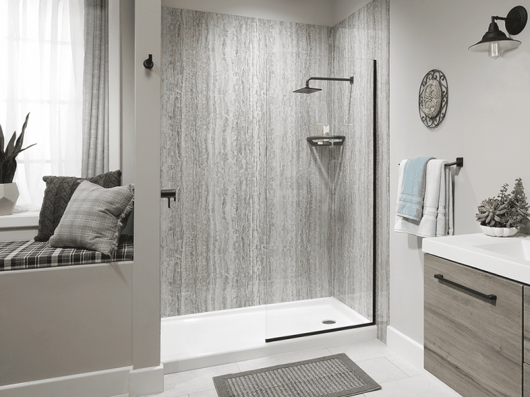Gray stone-look tub-to-shower conversion with glass door and black fixtures