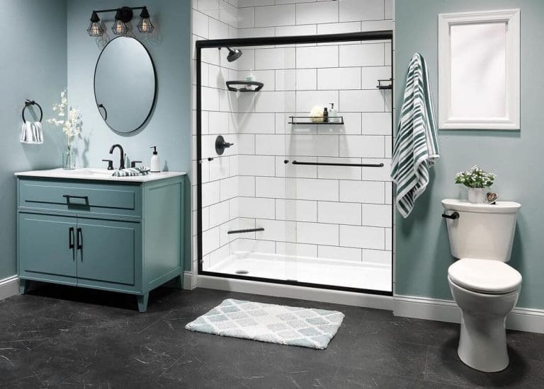 White subway-tile shower with black frame, teal vanity, and toilet